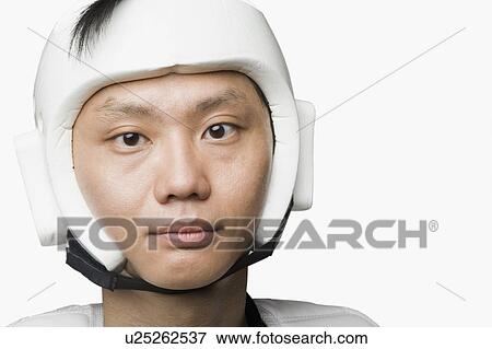 Stock Photo - Portrait of a mid adult man wearing a sports helmet. Fotosearch