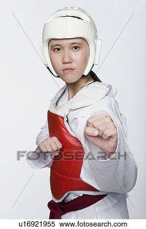 Stock Photography - Portrait of a young woman practicing kickboxing. Fotosearch