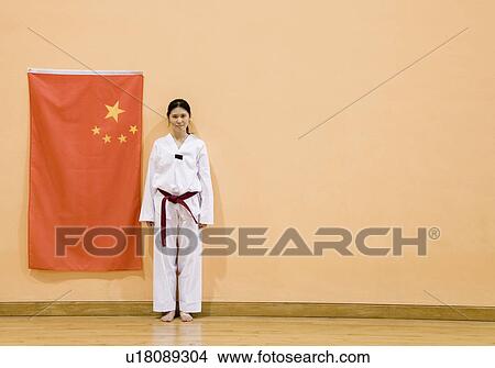 Portrait of a young woman standing near a Chinese flag View Large Photo Image Picture - Portrait of a young woman standing near a Chinese flag. Fotosearch