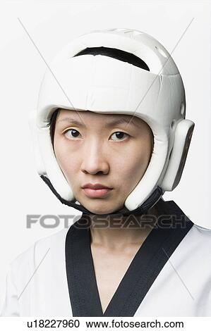 Stock Image - Portrait of a young woman wearing a sports helmet. Fotosearch