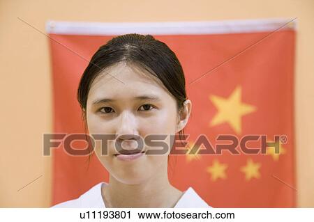 Portrait of a young woman with a Chinese flag in the background View Large Photo Image Stock Image - Portrait of a young woman with a Chinese flag in the background. Fotosearch