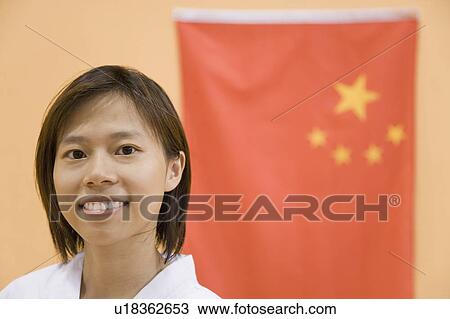 Portrait of a young woman with a Chinese flag in the background View Large Photo Image Stock Image - Portrait of a young woman with a Chinese flag in the background. Fotosearch