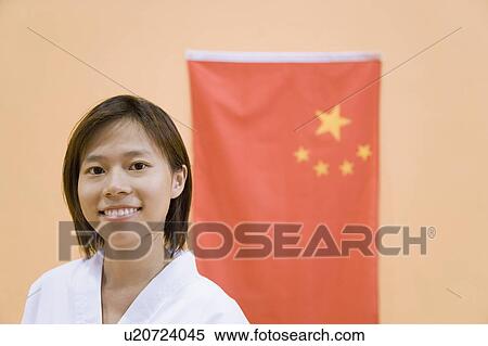 Portrait of a young woman with a Chinese flag in the background View Large Photo Image Stock Photography - Portrait of a young woman with a Chinese flag in the background. Fotosearch