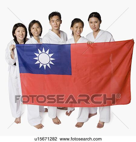 Stock Image - Portrait of four young women and a young man holding a Taiwanese flag. Fotosearch