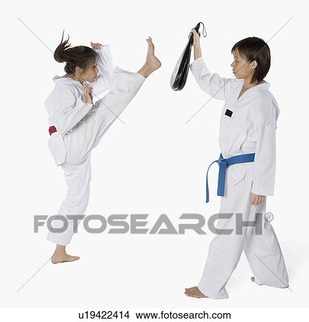 Side profile of two young women practicing karate View Large Photo Image Picture - Side profile of two young women practicing karate. Fotosearch