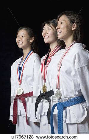 Three young women standing with their medals and smiling View Large Photo Image Stock Photo - Three young women standing with their medals and smiling. Fotosearch