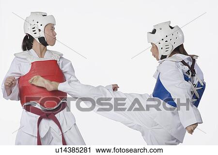 Stock Image - Two taekwondo players fighting. Fotosearch