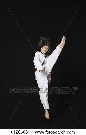 Young woman performing front kick View Large Photo Image Stock Photo - Young woman performing front kick. Fotosearch