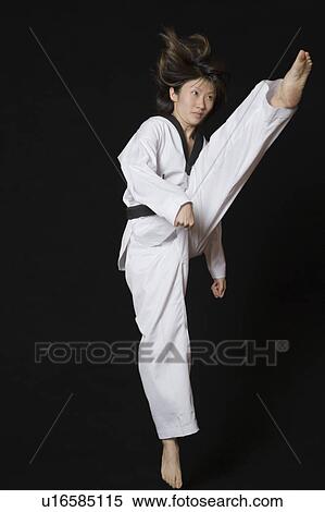 Young woman performing front kick View Large Photo Image Stock Photography - Young woman performing front kick. Fotosearch