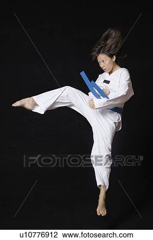 Young woman performing round kick View Large Photo Image Stock Image - Young woman performing round kick. Fotosearch