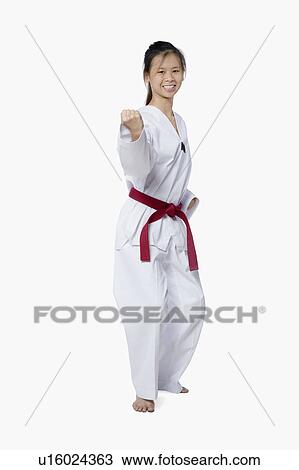 Young woman practicing karate and smiling View Large Photo Image Stock Image - Young woman practicing karate and smiling. Fotosearch