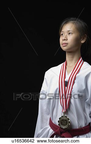 Young woman standing with a medal around her neck View Large Photo Image Stock Image - Young woman standing with a medal around her neck. Fotosearch