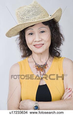 Portrait of a senior woman standing with her arms crossed View Large Photo Image Picture - Portrait of a senior woman standing with her arms crossed. Fotosearch
