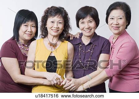 Portrait of three senior women and a mature woman standing together and smiling View Large Photo Image Stock Photograph - Portrait of three senior women and a mature woman standing together and smiling. Fotosearch