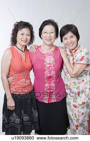 Portrait of three senior women standing together and smiling View Large Photo Image Stock Image - Portrait of three senior women standing together and smiling. Fotosearch