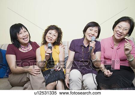 Three senior women and a mature woman singing in front of microphones View Large Photo Image Stock Photography - Three senior women and a mature woman singing in front of microphones. Fotosearch