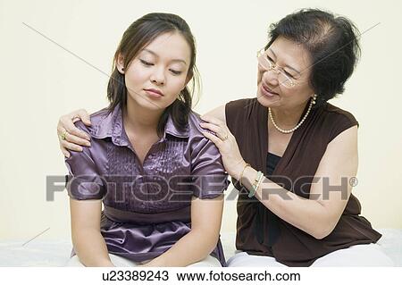 Close-up of a senior woman consoling her daughter View Large Photo Image Stock Image - Close-up of a senior woman consoling her daughter. Fotosearch