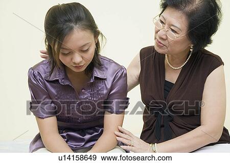 Close-up of a senior woman consoling her daughter View Large Photo Image Stock Photo - Close-up of a senior woman consoling her daughter. Fotosearch