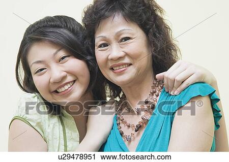 Stock Image - Portrait of a senior woman and her daughter smiling. Fotosearch