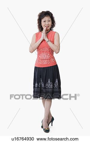 Portrait of a senior woman standing with her arms folded View Large Photo Image Stock Image - Portrait of a senior woman standing with her arms folded. Fotosearch