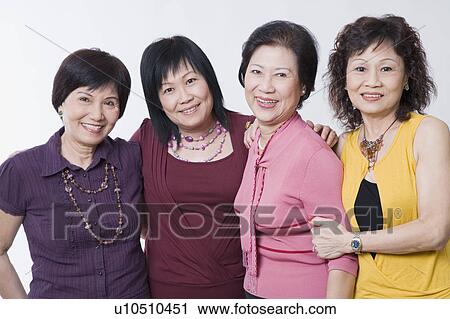 Portrait of three senior women and a mature woman standing together and smiling View Large Photo Image Stock Image - Portrait of three senior women and a mature woman standing together and smiling. Fotosearch