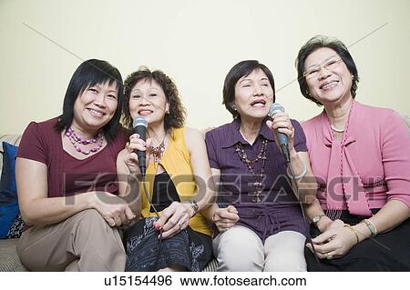 Three senior women and a mature woman singing in front of microphones View Large Photo Image Stock Photograph - Three senior women and a mature woman singing in front of microphones. Fotosearch