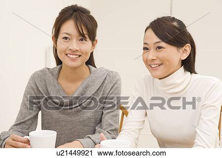 Three young women holding cup View Large Photo Image Stock Image - Three young women holding cup. Fotosearch