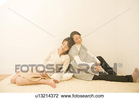 Stock Image - Two young women relaxing. Fotosearch