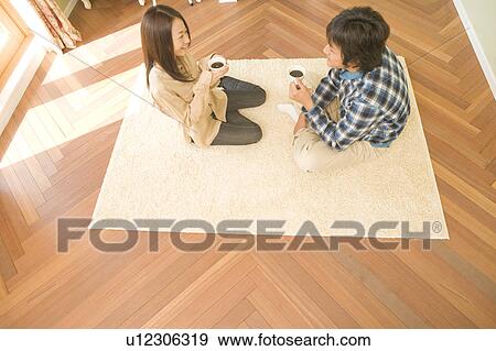 Young couple drinking coffee View Large Photo Image Stock Photo - Young couple drinking coffee. Fotosearch