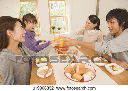 Young man and young women having home party View Large Photo Image Stock Image - Young man and young women having home party. Fotosearch