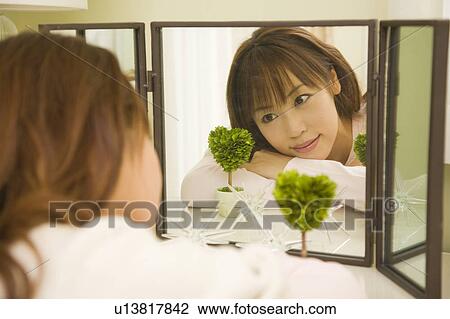 Young woman looking mirror View Large Photo Image Stock Image - Young woman looking mirror. Fotosearch