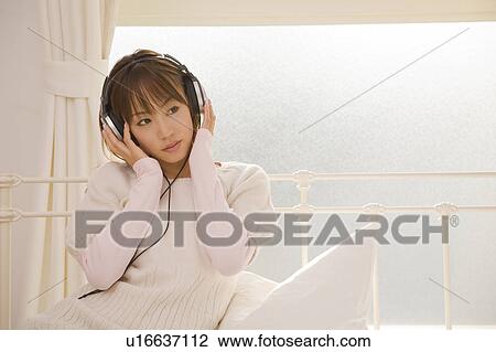 Young woman wearing headphone View Large Photo Image Stock Image - Young woman wearing headphone. Fotosearch