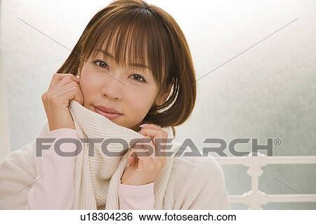 Stock Photograph - Young woman wearing muffler. Fotosearch