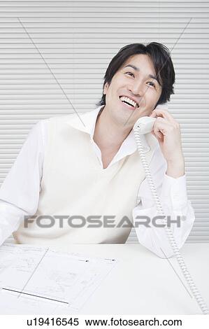 Stock Photography - Businessman talking by telephone. Fotosearch
