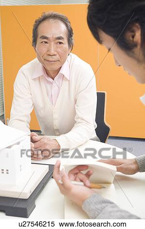 Businessman talking to colleague View Large Photo Image Stock Photography - Businessman talking to colleague. Fotosearch