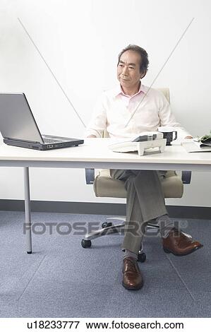 Businessman working in Office View Large Photo Image Stock Photo - Businessman working in Office. Fotosearch