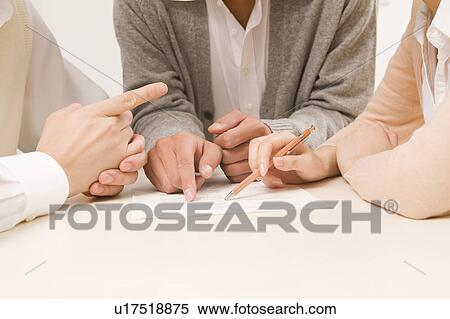 Stock Photography - Hands of discussing business people. Fotosearch