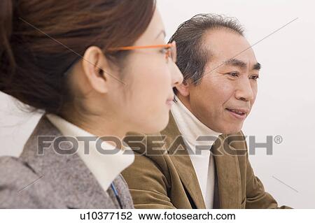 Mature man and young woman working View Large Photo Image Stock Image - Mature man and young woman working. Fotosearch