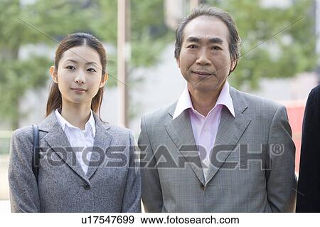 Stock Photo - Portrait of businessman and businesswoman in winter clothes. Fotosearch