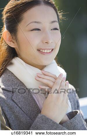 Stock Image - Portrait of businesswoman in winter clothes. Fotosearch