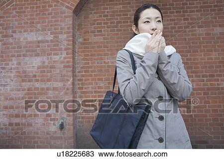Stock Image - Portrait of businesswoman in winter clothes. Fotosearch