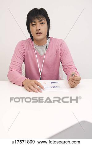 Stock Photo - Portrait of young man in office. Fotosearch