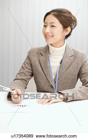 Portrait of young woman in office View Large Photo Image Stock Photo - Portrait of young woman in office. Fotosearch