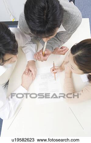 Three people discussing in office View Large Photo Image Stock Image - Three people discussing in office. Fotosearch
