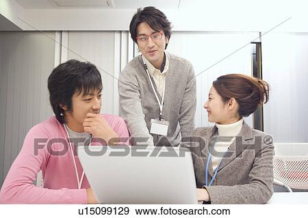 Three people discussing in office View Large Photo Image Stock Photo - Three people discussing in office. Fotosearch