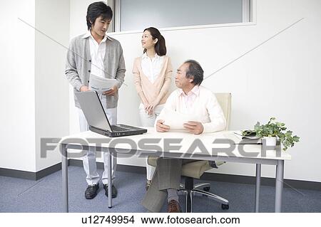 Three people working in office View Large Photo Image Picture - Three people working in office. Fotosearch