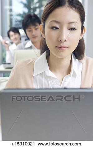 Stock Image - Three people working in office. Fotosearch