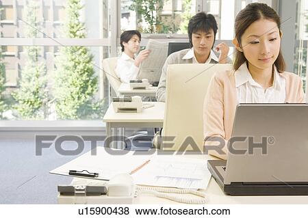 Three people working in office View Large Photo Image Stock Photo - Three people working in office. Fotosearch