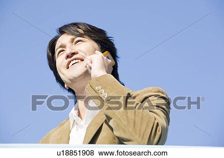 Young woman talking over mobile phone View Large Photo Image Stock Photo - Young woman talking over mobile phone. Fotosearch