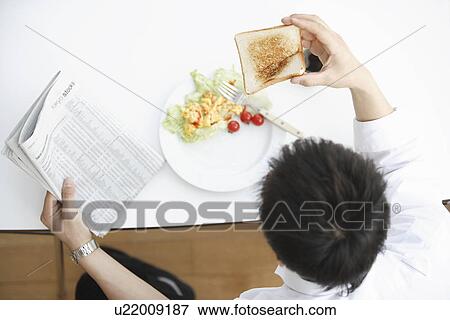 Stock Photo - Businessman having breakfast. Fotosearch